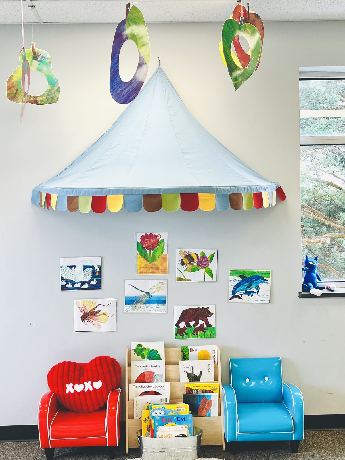 The Joyful Steps classroom reading corner with a soft canopy, picture books, and small armchairs